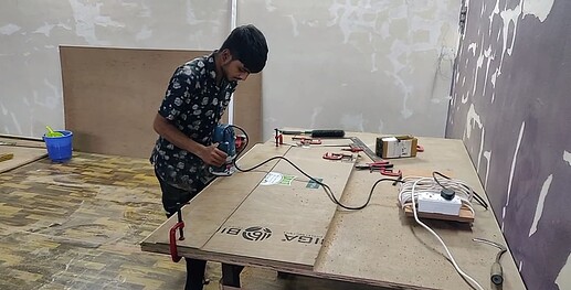 Ali creating the rabbet at the edge of the planks using a router.